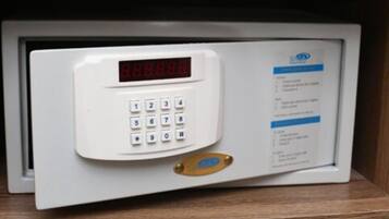 A microwave with a digital display and keypad, placed in a wooden cabinet.
