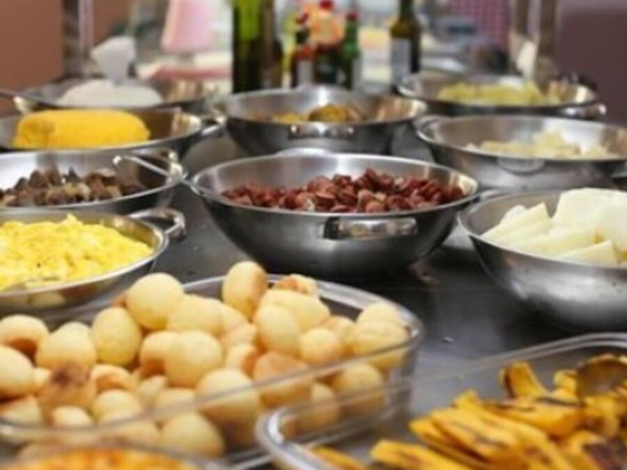 A buffet with various food items including fruits, vegetables, and prepared dishes.
