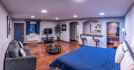 Desk, laptop workspace, iron/ironing board, bed sheets