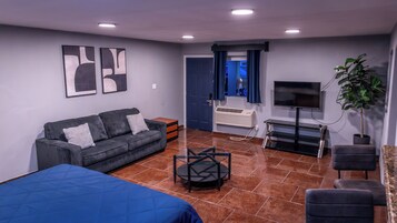 Desk, laptop workspace, iron/ironing board, bed sheets