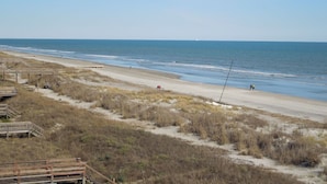 A beach with wooden walkways and a sandy shore.