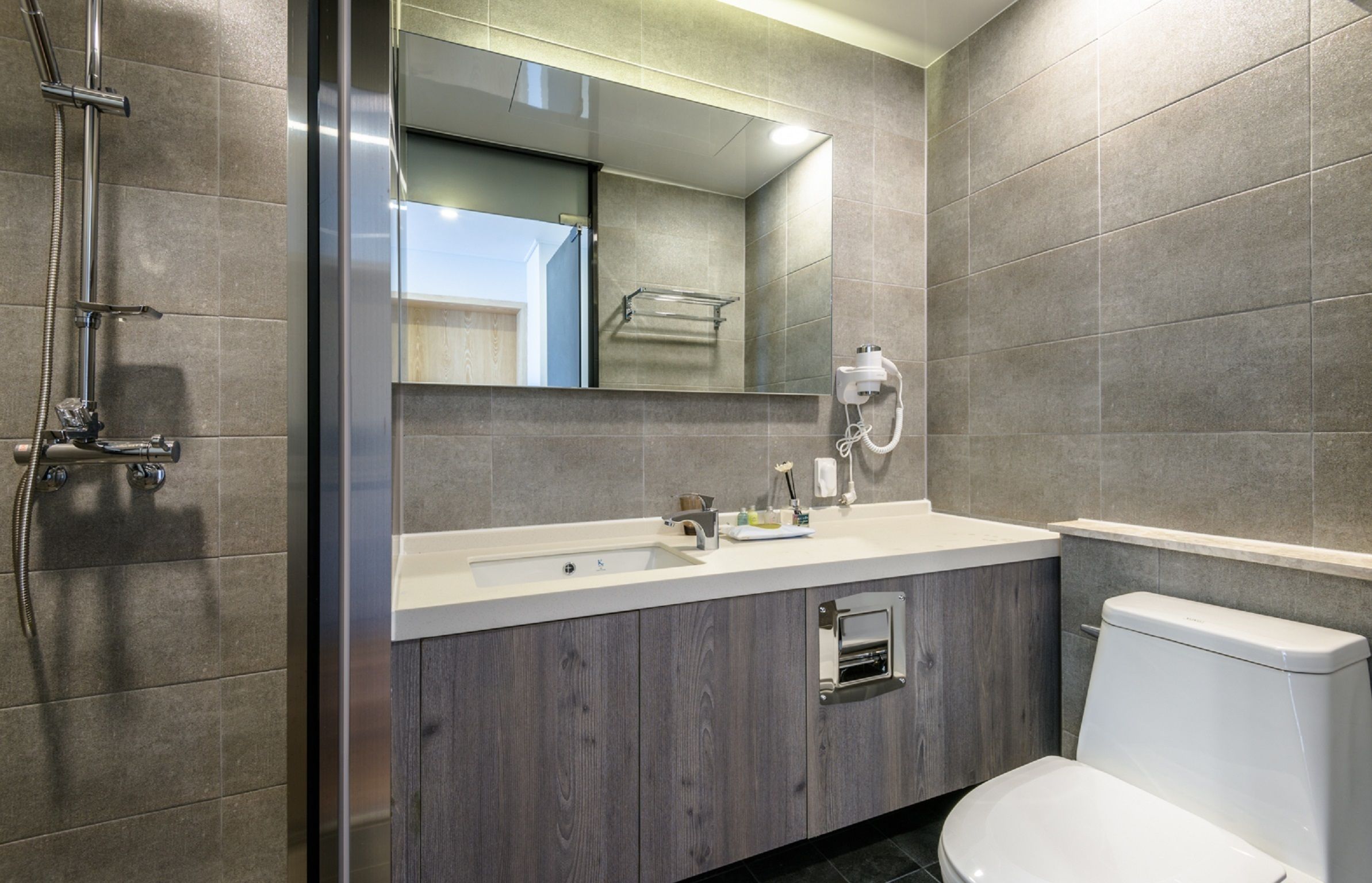 shower, hair dryer, slippers, towels