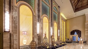 A luxurious lobby with marble floors, ornate vases, and a seating area with a view of the cityscape. - Felton Grand Hotel Bazhong (Bazhong)