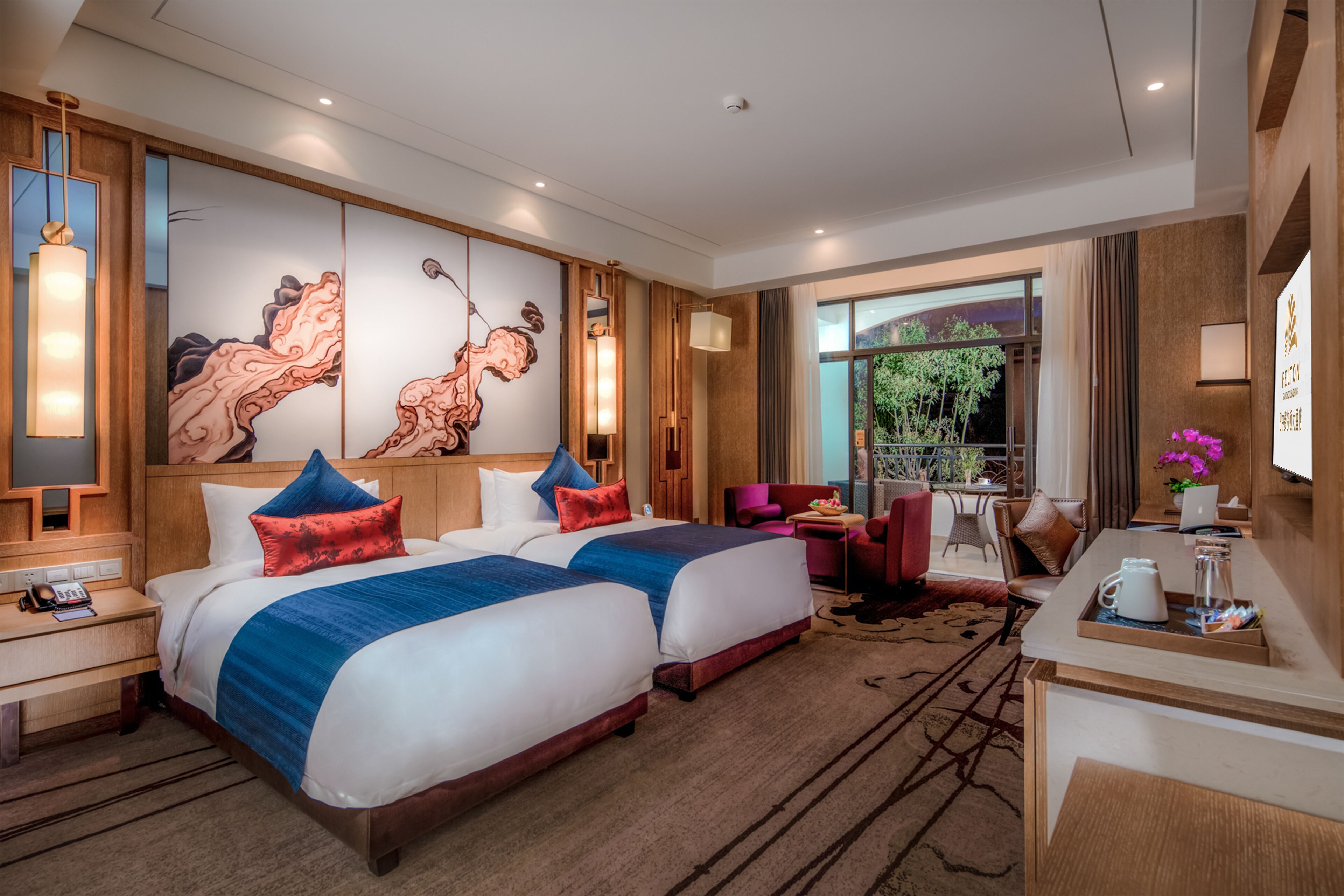 A hotel room with two beds, a desk, a chair, and a large window.