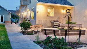 A residential house with a covered patio, outdoor seating, and a barbecue grill. - LV5 Upper Floor Suite (La Verkin)