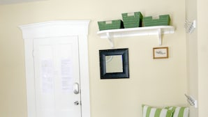 A room with a white door, a bench with green cushions, a mirror, and green storage boxes on a shelf. - Great Ski or Summer Rental - 5 miles to Okemo/Ludlow, 25 Gorgeous Acres (Ludlow)