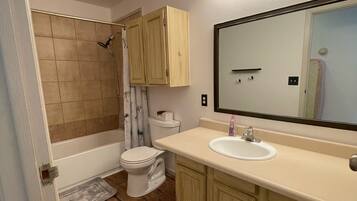 Bathtub, towels, soap, toilet paper