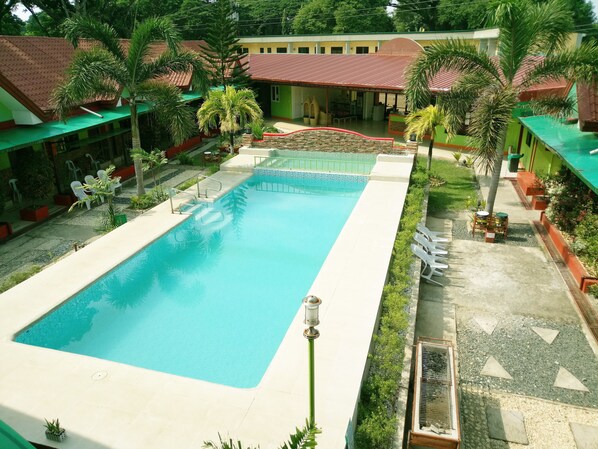 Outdoor pool, open 8 AM to 9 PM, pool umbrellas