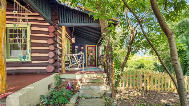 A rustic log cabin with a wooden porch, a stone pathway leading to the entrance, and a wooden fence surrounding the property. - CLOSE TO DOWNTOWN- The Peacock Retreat- Dogs Stay Free  (Asheville)