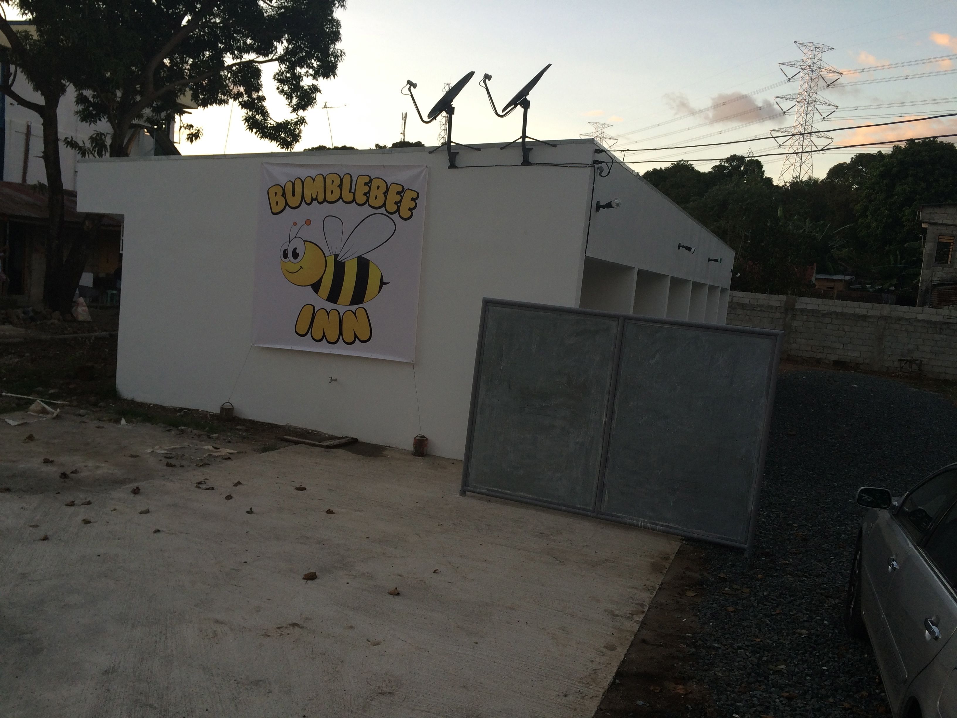 A building with a sign reading "Bumblebee Inn" featuring a cartoon bee.