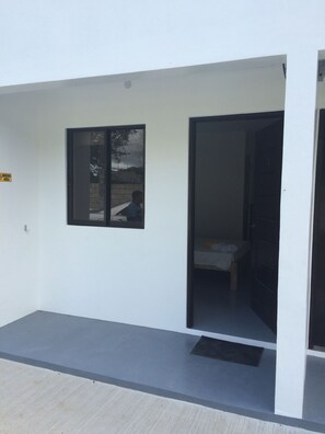 A building entrance with a door leading to a room. - Bumblebee Inn (Tanay)