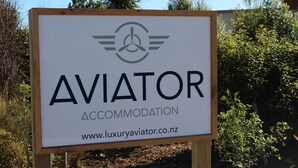 A sign for 'AVIATOR ACCOMMODATION' with a website URL.