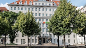 A large, historic building with a prominent sign for Travel24 Hotel. - Travel24 Hotel (Leipzig)
