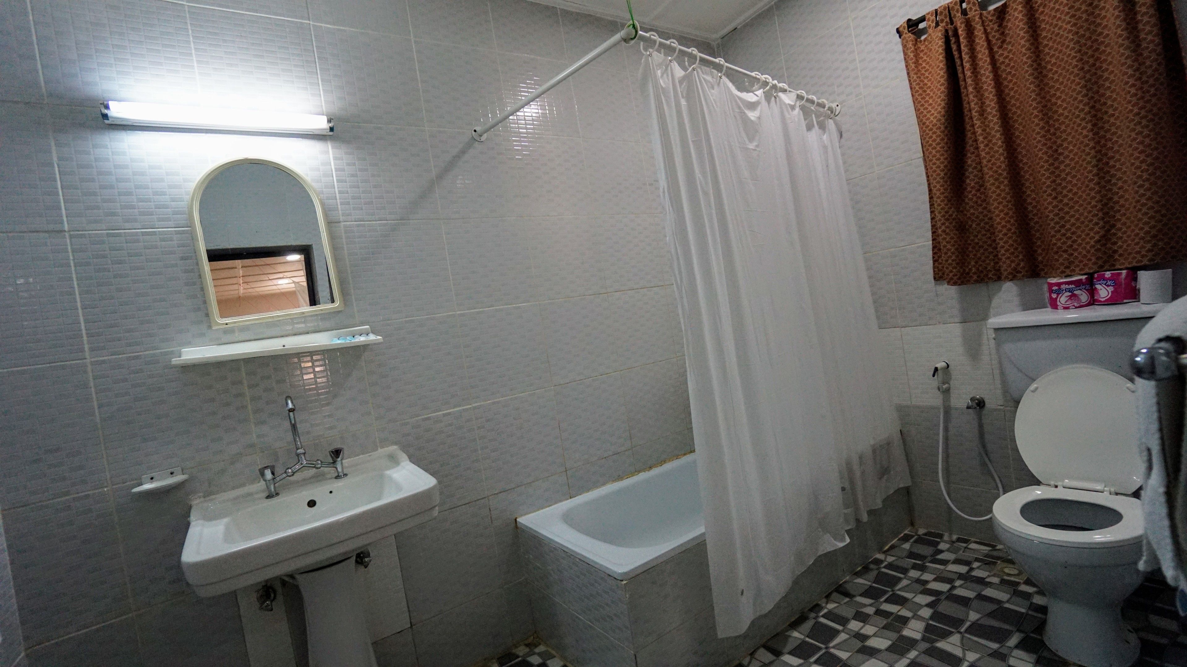 A bathroom with a sink, toilet, and bathtub.