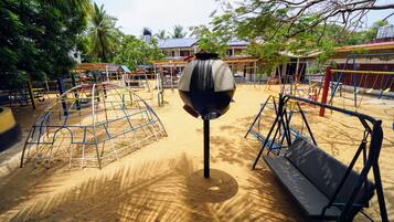 Kids can play on the climbing frame, swings, and in the sandbox.