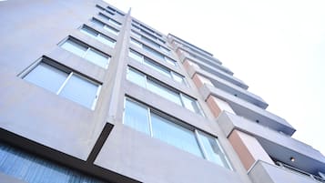 A high-rise building with multiple floors, large windows, and a modern architectural design.