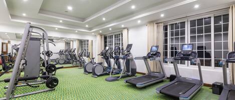 A gym with treadmills, elliptical machines, and weight equipment.