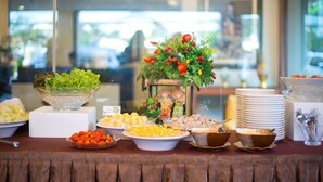 Une table de buffet garnie de divers plats et agrémentée d’un centre de table décoratif.