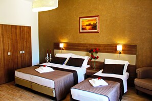 Deluxe Triple Room, Garden View | Minibar, in-room safe, desk, iron/ironing board