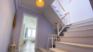 A staircase with a white railing and a patterned floor.