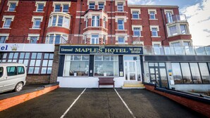 The Maples Hotel with a traditional facade, a parking area, and a van parked in front. - The Maples Hotel (Blackpool)