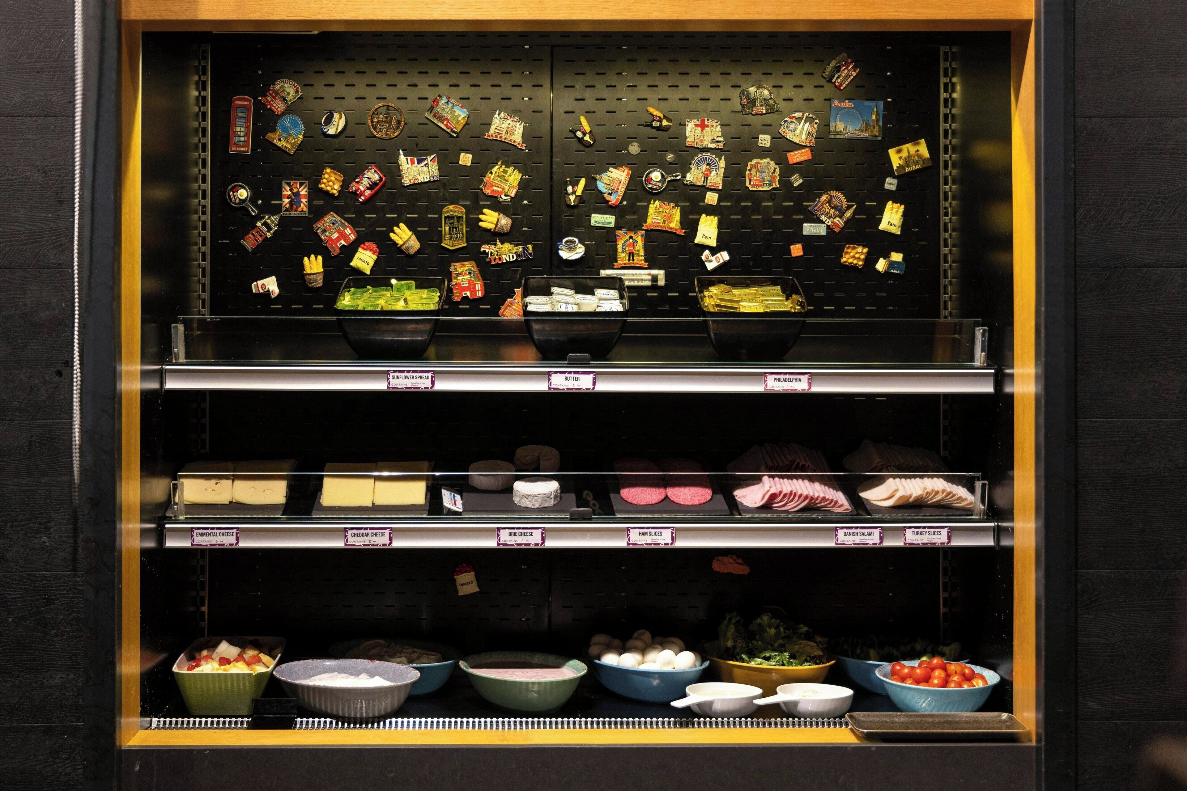 A deli display with various cheeses and condiments.