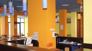 A hotel reception area with a counter, seating, and a window. - Sveti Vlas Hotel (Sveti Vlas)