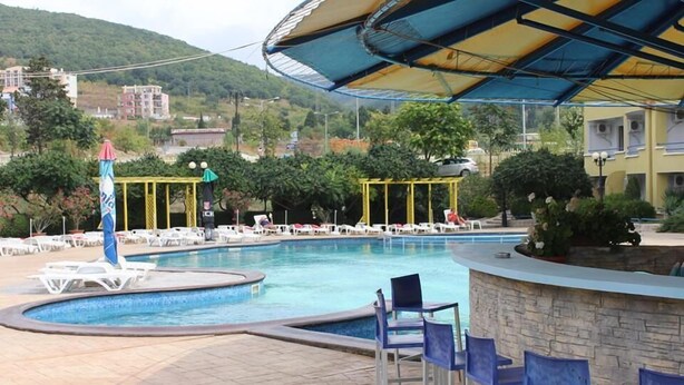 A swimming pool with lounge chairs and a covered seating area. - Sveti Vlas Hotel (Sveti Vlas)