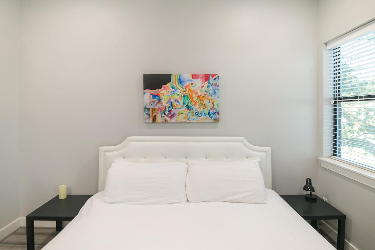 Premium bedding, desk, laptop workspace, iron/ironing board