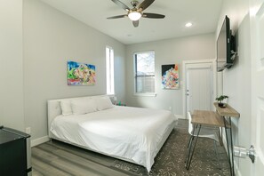 Premium bedding, desk, laptop workspace, iron/ironing board - Montrose Guesthouse Suites (Houston)