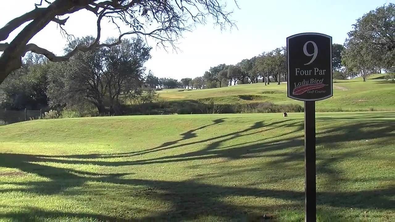 A golf course sign labeled "9 Four Par Lady Bird Golf Course."