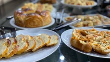 A buffet with various bread and pastries.