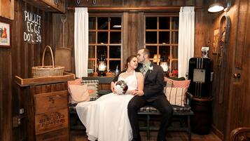 A rustic room with wooden walls, a vintage lamp, a wicker basket, and a sign reading "PULLET EGGS DOZ 30."