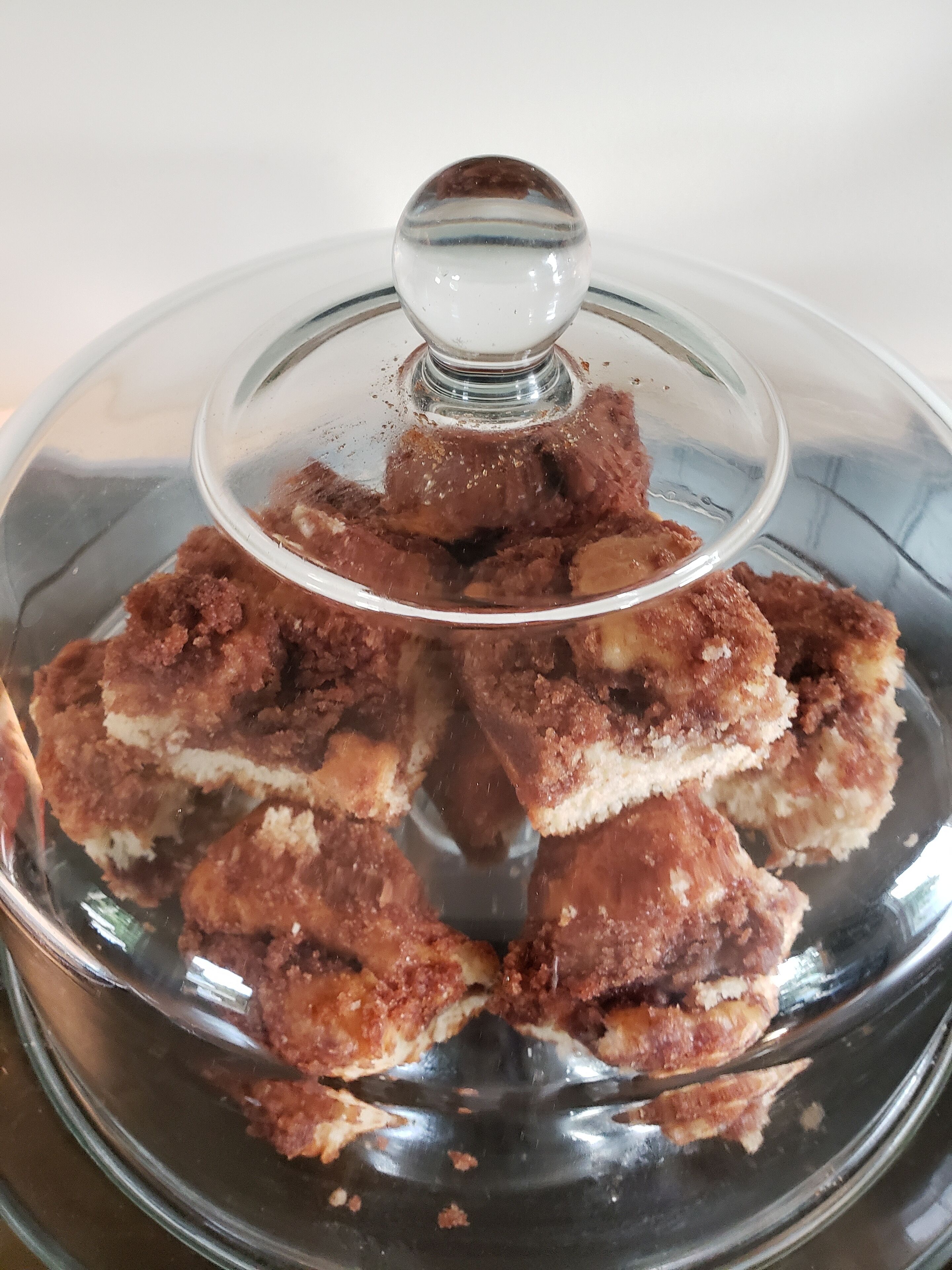 A glass-covered food display with a lid.