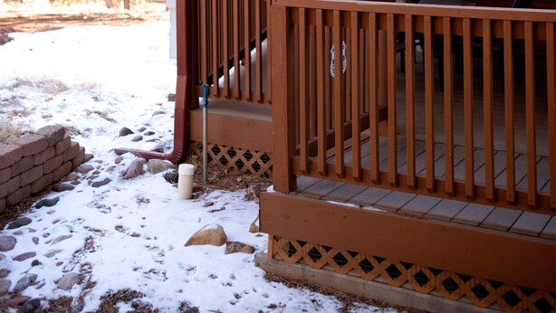 A wooden cabin with a porch, a window, and a door. -  SWEET, IMPECCABLE CABIN IN THE PINES ! HIKING, LAKES! (Show Low)