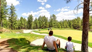 A golf course with a clear path, sand bunkers, and a group of people playing. -  SWEET, IMPECCABLE CABIN IN THE PINES ! HIKING, LAKES! (Show Low)