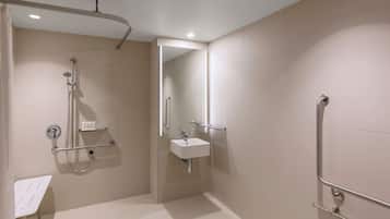 A modern bathroom with a walk-in shower, a sink, and a mirror.