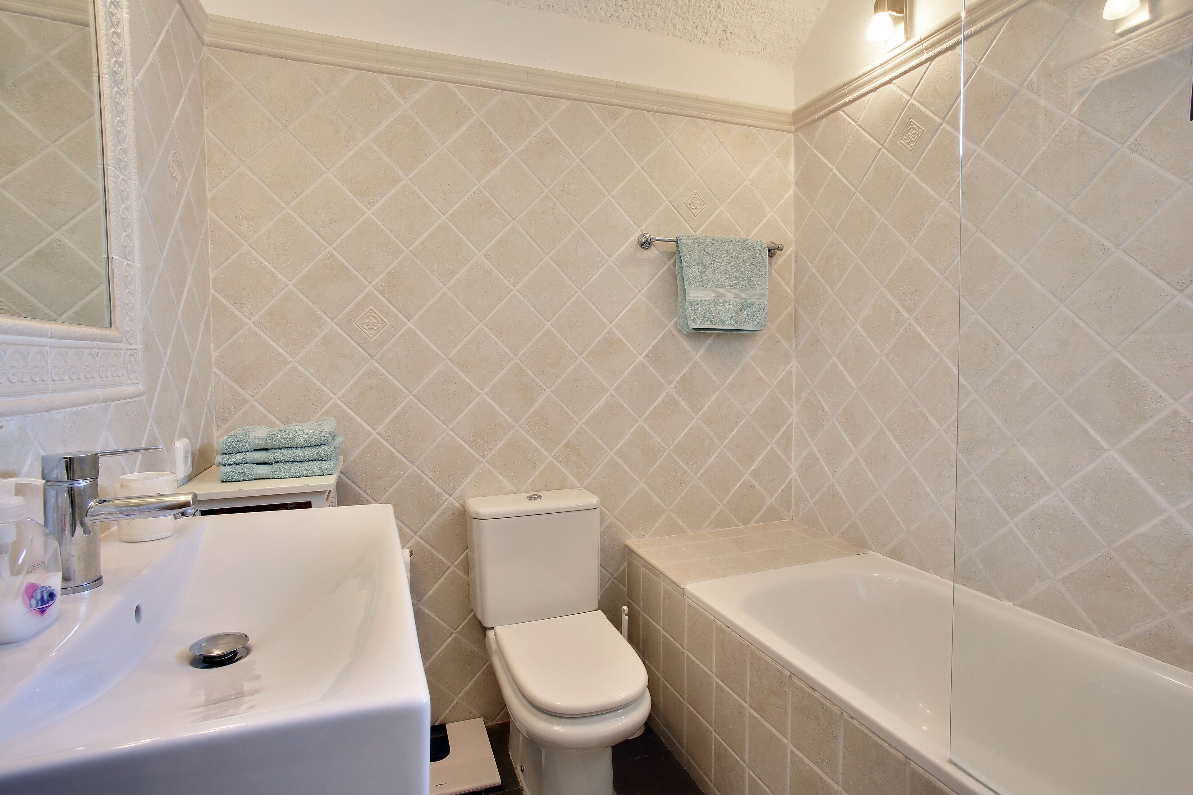 A bathroom with a sink, toilet, and bathtub.
