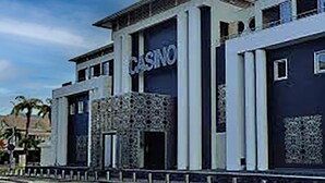 A building with a prominent "CASINO" sign, featuring a modern architectural style with a flat roof and large windows. - Cozy and modern charming villa 5 minutes walk from the beach (Le Gosier)