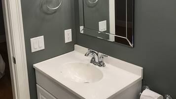 Shower, hair dryer, towels, shampoo