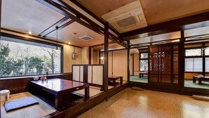A traditional Japanese room with tatami flooring, a low table, and sliding doors. - Hosenji Kanko Hotel Yumotoya (Kokonoe)