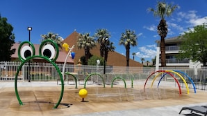 A water play area with colorful arches and a building in the background. - Comfortable condo close to mountain biking, swimming pools, national parks (St. George)