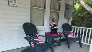 Two Adirondack chairs with American flag cushions on a wooden porch. - Experience old Oriental (Oriental)