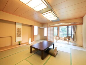 A traditional Japanese room with tatami flooring, a low table, and sliding doors.
