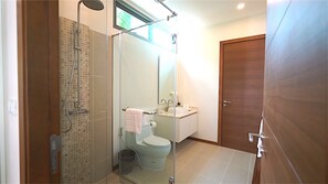 A modern bathroom with a glass-enclosed shower, a toilet, and a sink. - Rawai Ka Villa with Private Pool (Rawai)