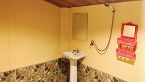 A bathroom with a white sink, a mirror, and a shower. - Janya Homestay (Ko Yao)