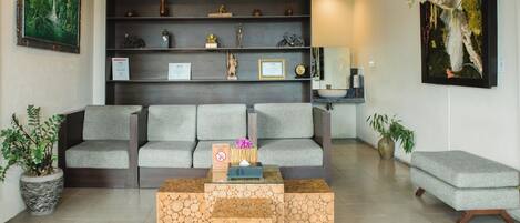 A modern living room with a sofa, a coffee table, and a bookshelf.