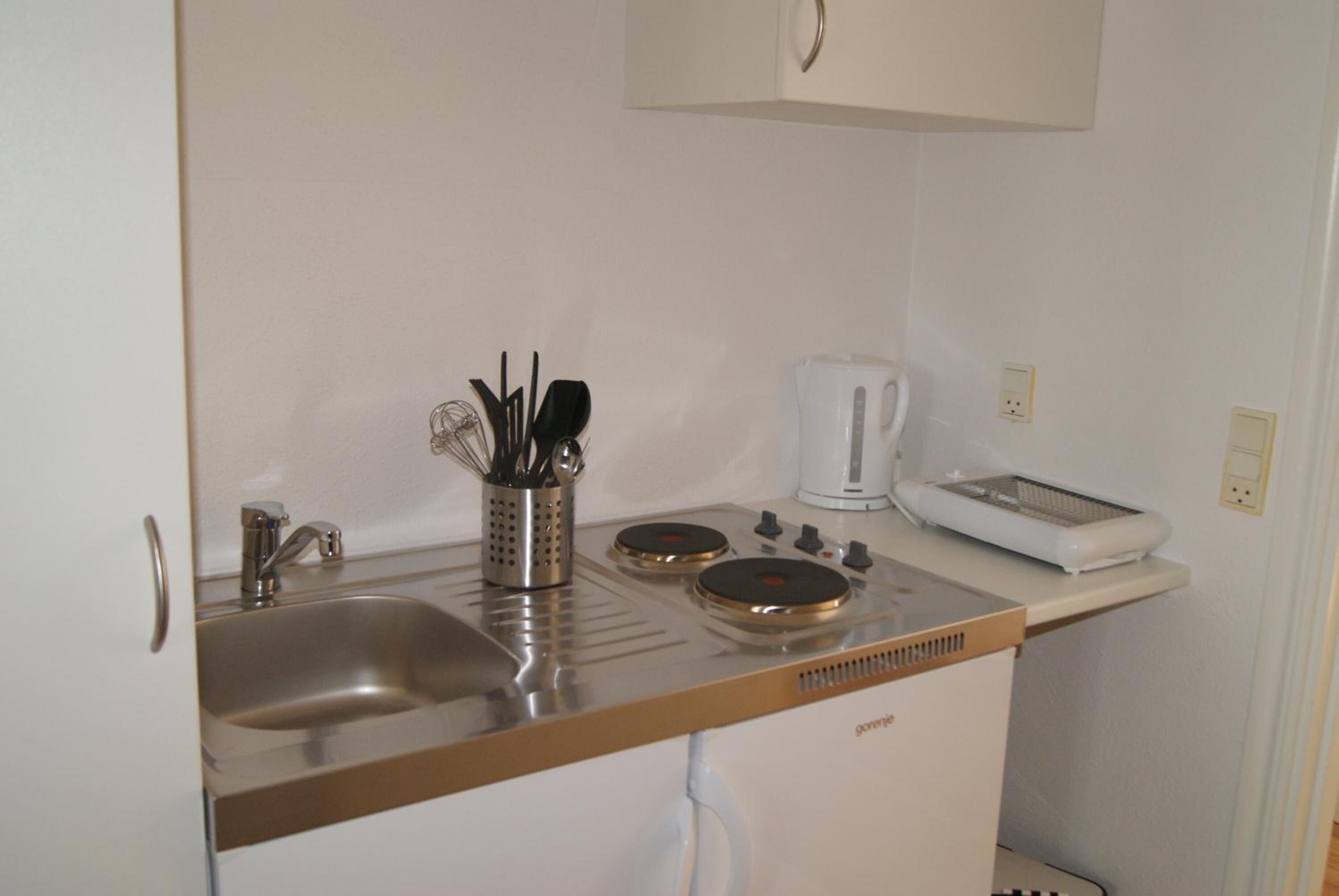 fridge, stovetop, electric kettle, cookware/dishes/utensils