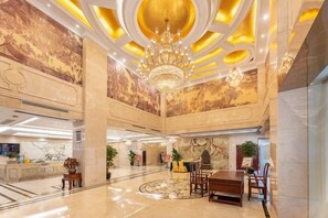 A spacious lobby with a grand chandelier, marble walls, and a reception desk. - Liang an International Hotel (Hangzhou)
