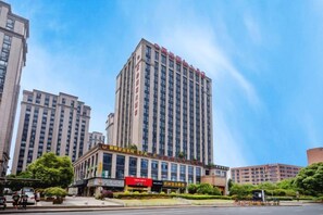 A high-rise hotel with multiple floors, a prominent entrance, and a clear sky. - Liang an International Hotel (Hangzhou)